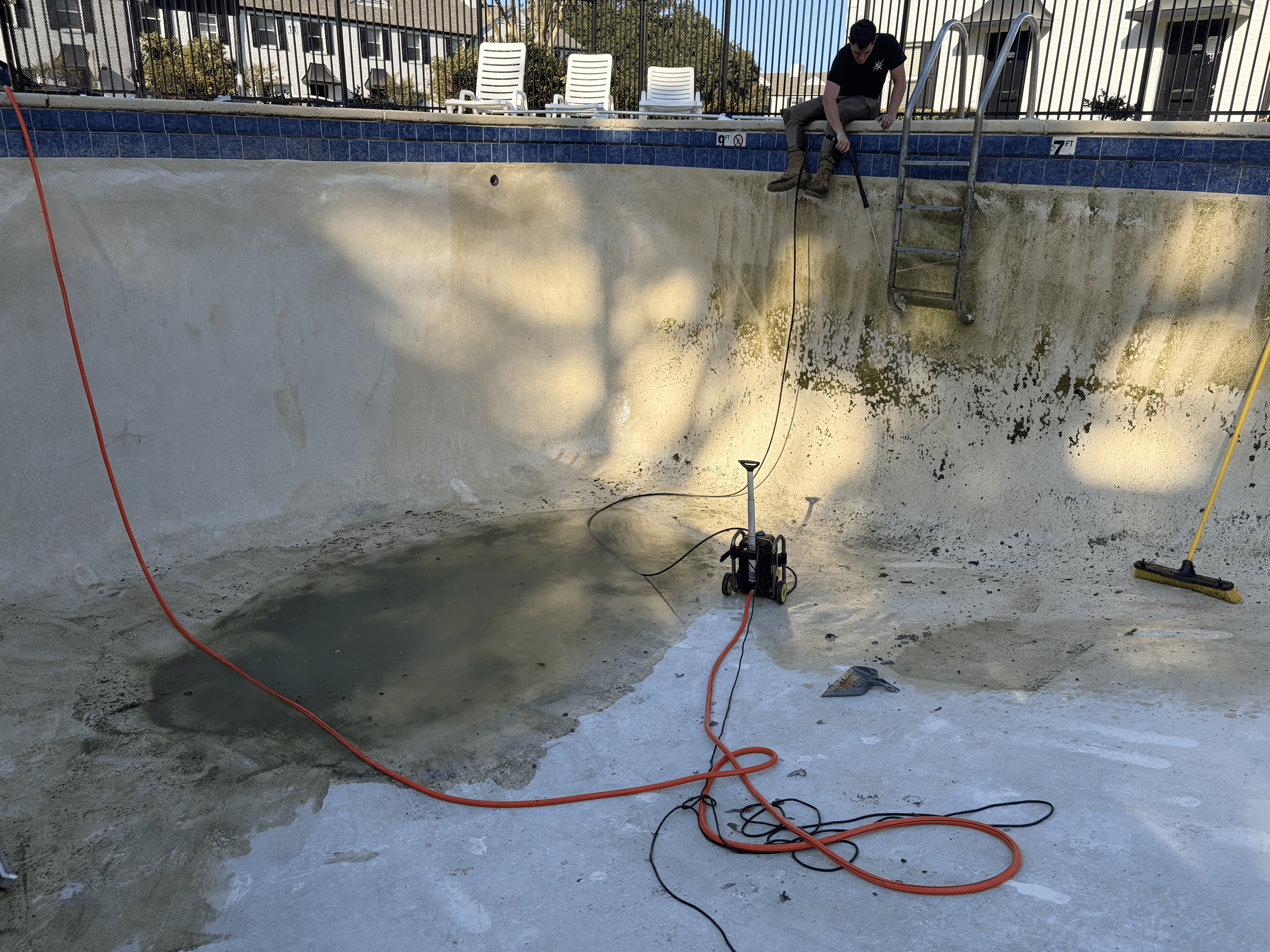 Pressure washing a drained pool in Shreveport